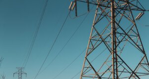 brown electric post under blue sky during daytime