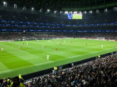 two teams playing soccer inside stadium