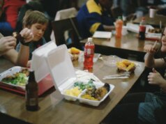 two children sitting beside dining table