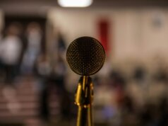 selective focus photography of brass-colored microphone