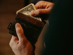 person getting 1 U.S. dollar banknote in wallet