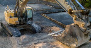 A small excavator sitting on top of a pile of dirt