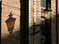 a street light next to a brick building