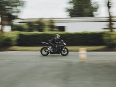 man riding motorcycle on road during daytime