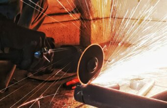 person grinding pipe steel wool photography