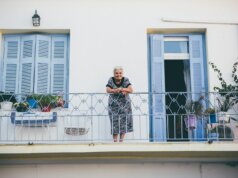 person standing on gray steel railings