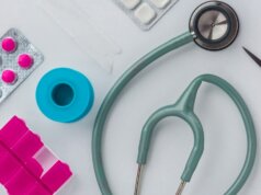 green and silver stethoscope on white envelope